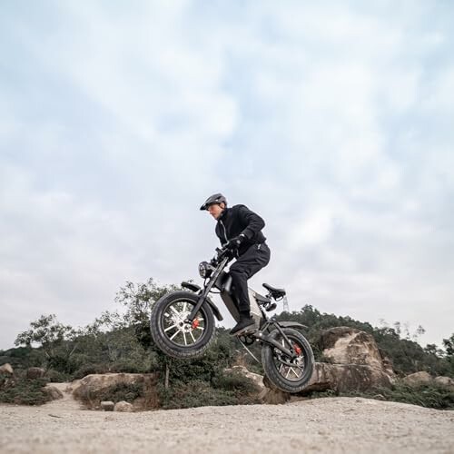 Person riding a bike off-road over rocky terrain